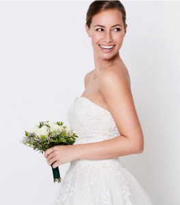 Women in Wedding Gown Holding Flowers