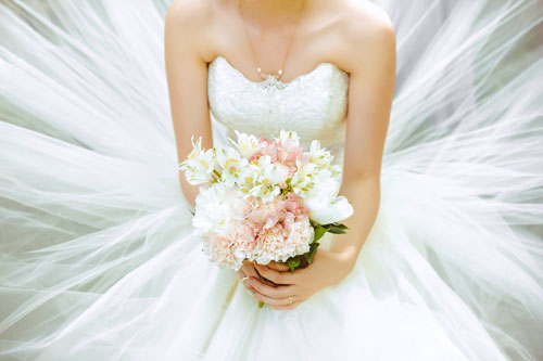 Women in Wedding Dress With Flowers